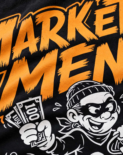 Close-up of the Marketplace Menace Tee print: orange lettering and a cartoon bandit holding a fistful of cash