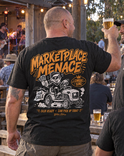 Back view of the Marketplace Menace Tee in a beer garden, orange Lowball King print on a black tee
